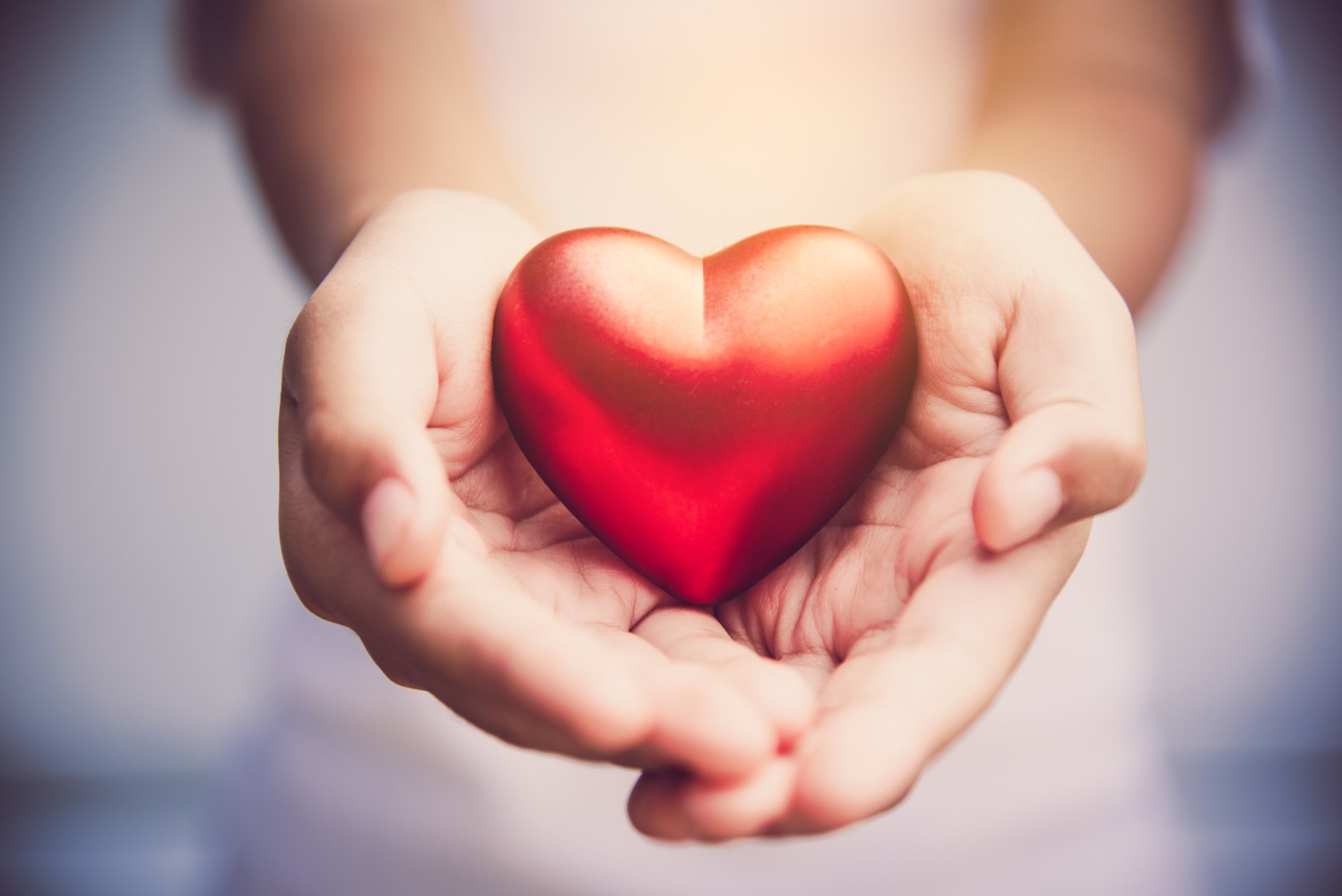 Woman Holding a Red Heart with Her Hands